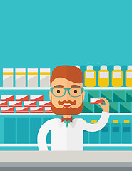 Image showing Young  pharmacy chemist man standing in drugstore. 