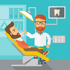 Image showing Dentist man examines a patient teeth in the clinic