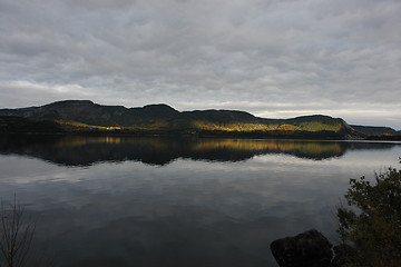 Image showing Sunlit mountain on cloudy day