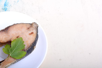 Image showing Frying pan with one roasted salmon steaks, view from above