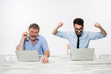 Image showing The two colleagues working together at office on white background