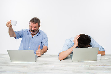 Image showing The two colleagues working together at office on white background