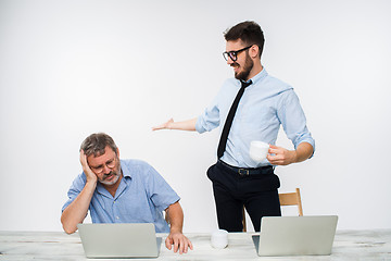 Image showing The two colleagues working together at office on white background