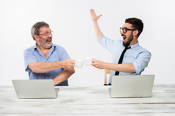 Image showing The two colleagues working together at office on white background