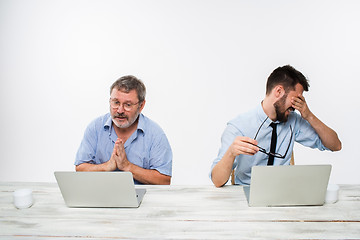 Image showing The two colleagues working together at office on white background