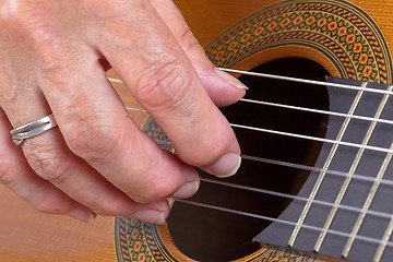 Image showing Old woman\'s hand playing guitar