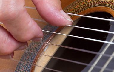 Image showing Old woman\'s hand playing guitar