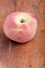 Image showing Peach on wooden plate