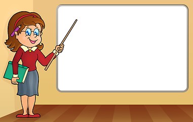 Image showing Woman teacher standing by whiteboard