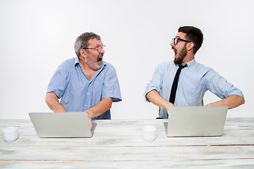 Image showing The two colleagues working together at office on white background