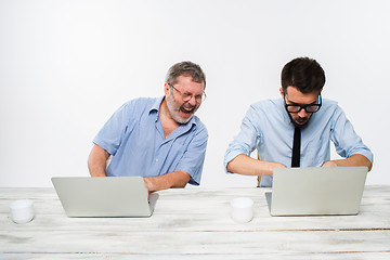 Image showing The two colleagues working together at office on white background