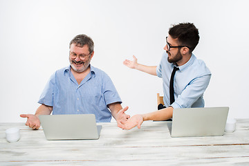 Image showing The two colleagues working together at office on white background