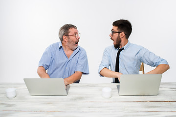 Image showing The two colleagues working together at office on white background