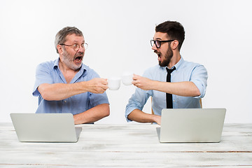 Image showing The two colleagues working together at office on white background