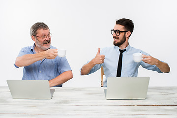 Image showing The two colleagues working together at office on white background