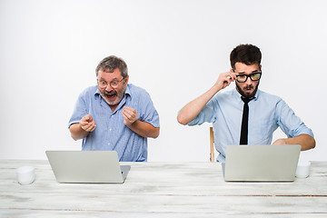 Image showing The two colleagues working together at office on white background