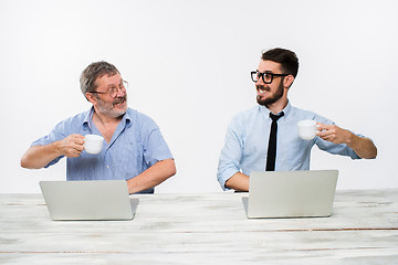 Image showing The two colleagues working together at office on white background