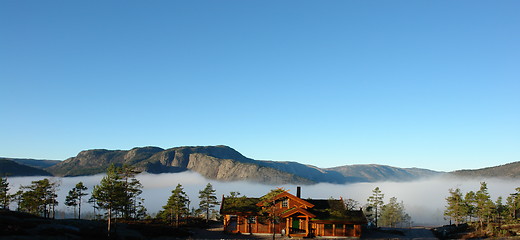 Image showing Loghouse above clouds