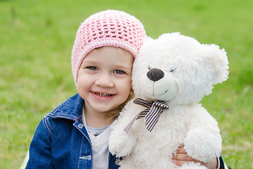 Image showing Girl hugging a teddy bear picnic