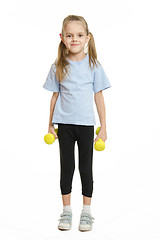 Image showing Six year old girl athlete standing with dumbbells