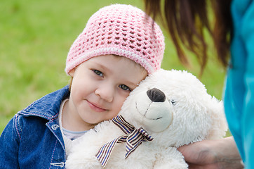 Image showing Tired girl lay on a teddy bear