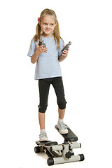 Image showing Six year old girl on a step simulator with expander in the hands of