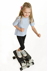 Image showing Six year old girl is engaged on a step simulator