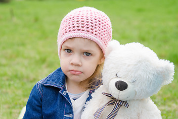 Image showing Offended girl with a teddy bear picnic