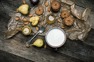 Image showing Tasty pears Cookies and milk on wooden table