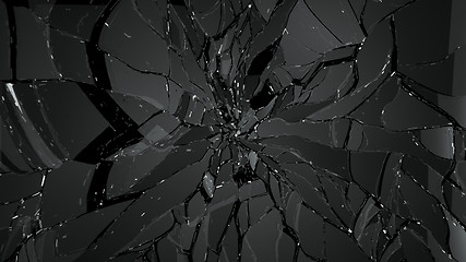 Image showing Pieces of splitted or cracked glass on black