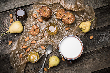 Image showing Cookies pears and yoghurt on wooden table