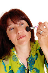 Image showing Woman putting makeup on her chic\'s.