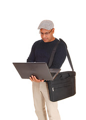 Image showing A Hispanic man working on his laptop.