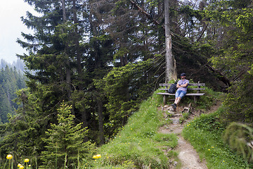 Image showing Hiker takes a break and enjoys the view