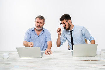 Image showing The two colleagues working together at office on white background