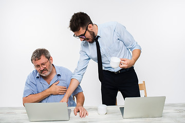 Image showing The two colleagues working together at office on white background