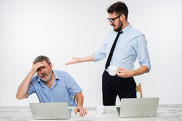 Image showing The two colleagues working together at office on white background