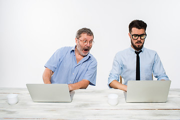 Image showing The two colleagues working together at office on white background