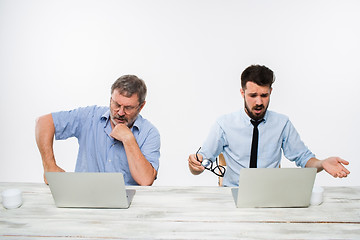 Image showing The two colleagues working together at office on white background