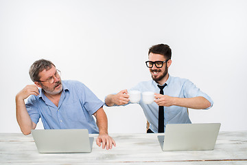 Image showing The two colleagues working together at office on white background