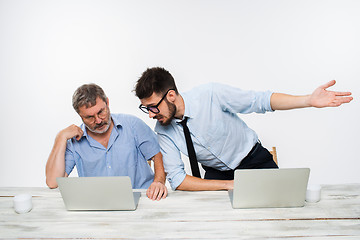 Image showing The two colleagues working together at office on white background