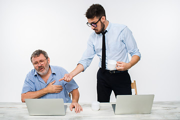 Image showing The two colleagues working together at office on white background