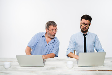 Image showing The two colleagues working together at office on white background