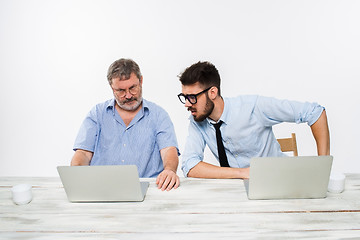 Image showing The two colleagues working together at office on white background