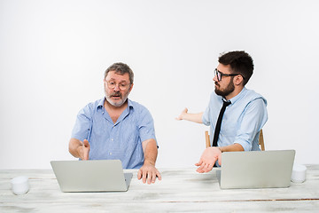 Image showing The two colleagues working together at office on white background