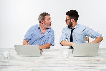 Image showing The two colleagues working together at office on white background