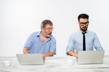 Image showing The two colleagues working together at office on white background