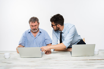 Image showing The two colleagues working together at office on white background