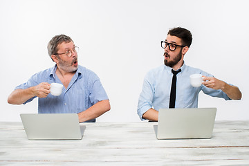 Image showing The two colleagues working together at office on white background