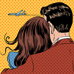 Image showing Loving couple looking at a plane taking off in the sky